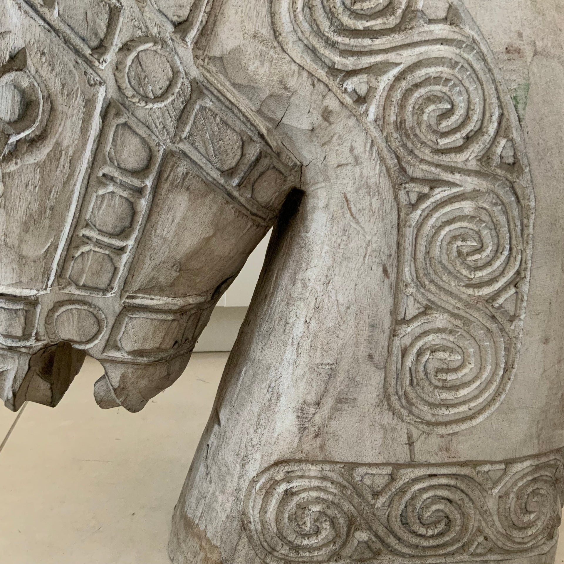 Hand-carved weathered wooden horse sculpture with spiral details, 46cm tall.