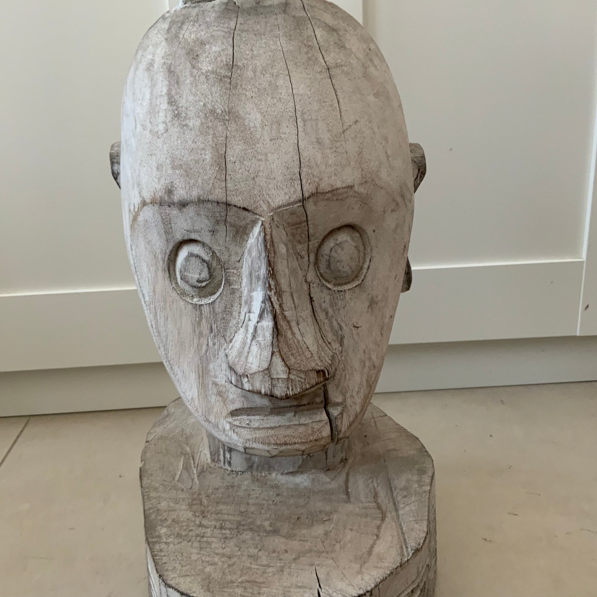 Front and side profile of a large 56cm hand-carved whitewashed wooden tribal head statue with geometric base details.