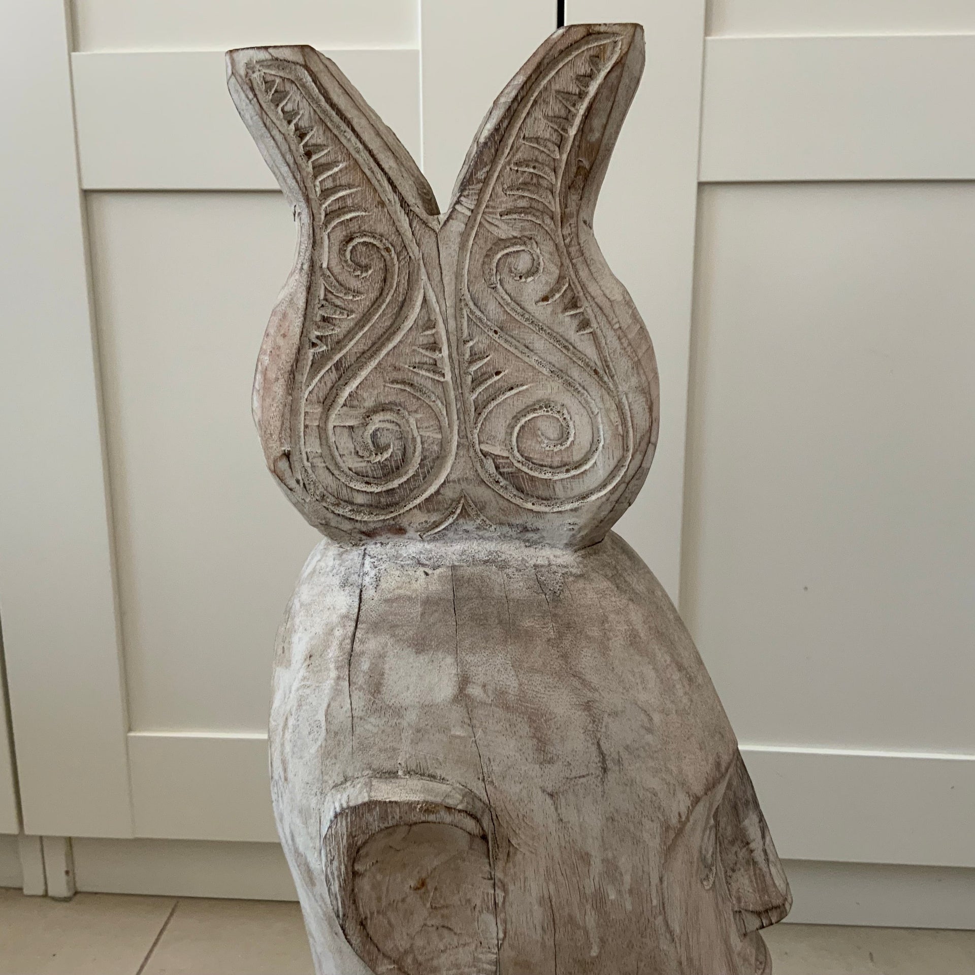 Front and side profile of a large 56cm hand-carved whitewashed wooden tribal head statue with geometric base details.