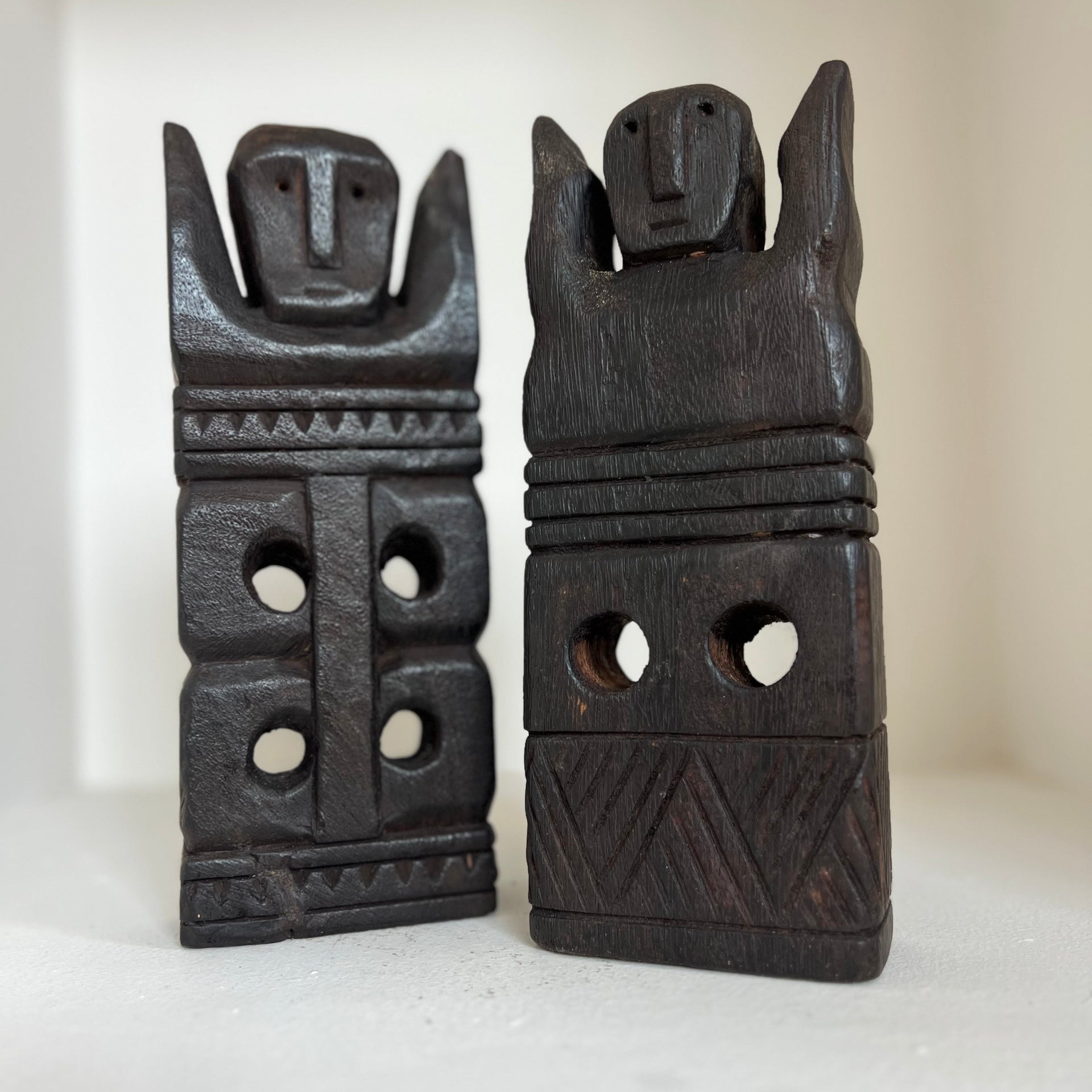Sets of two wooden artifacts.