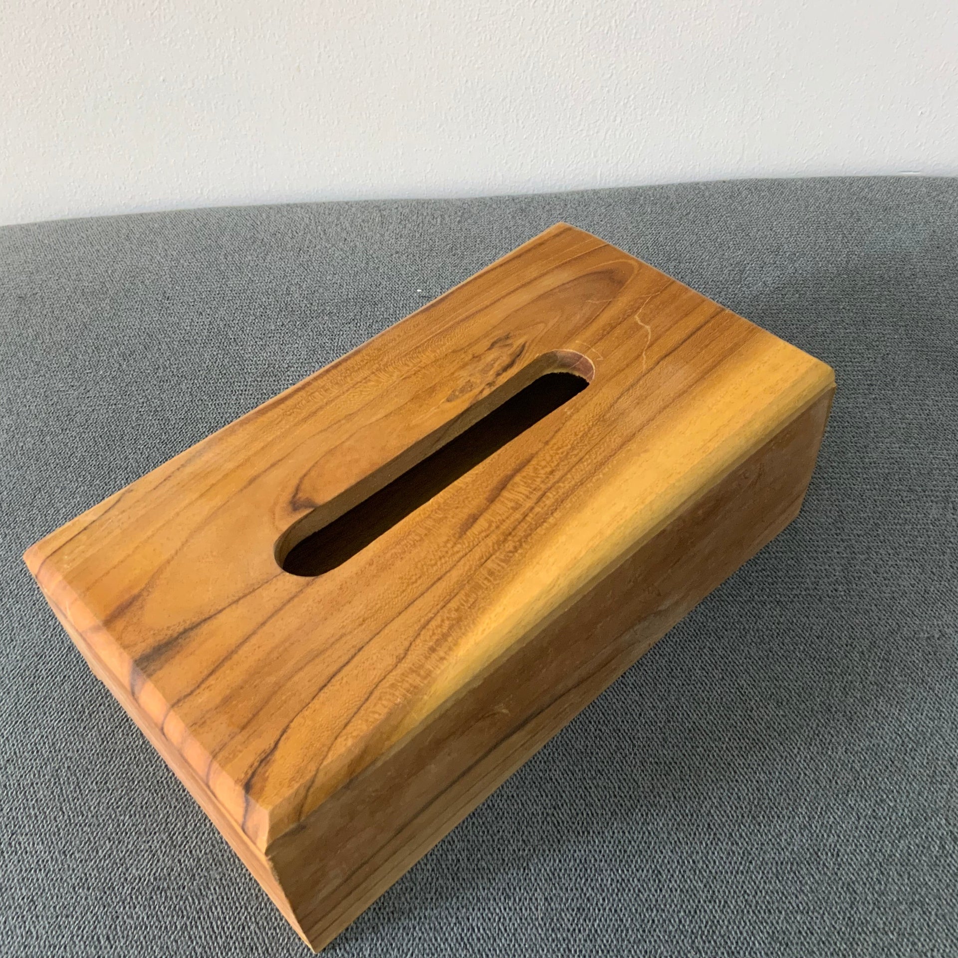 Natural wood rectangular tissue box cover with a smooth finish.