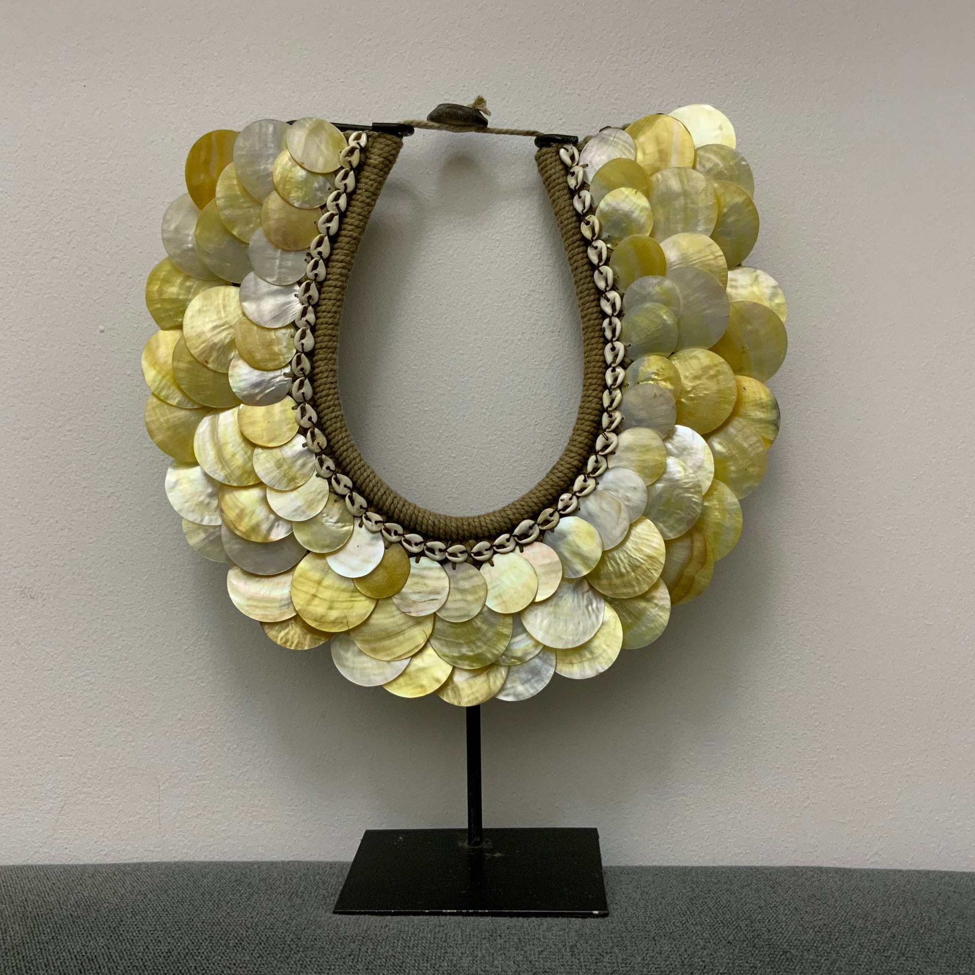 Indonesian tribal shell decor on stand, coastal luxe home accessory, wabi-sabi style mother of pearl shell sculpture for shelf styling and organic interior design.