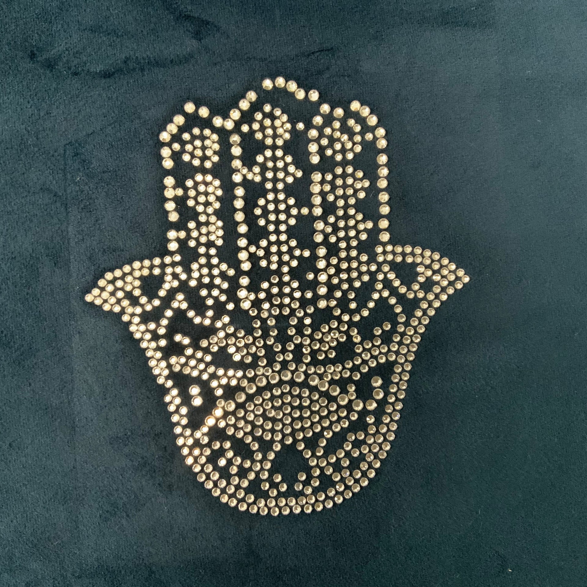 Navy blue velvet decorative pillow cover embellished with a shimmering silver studded Hamsa Hand design in a minimalist, elegant style.