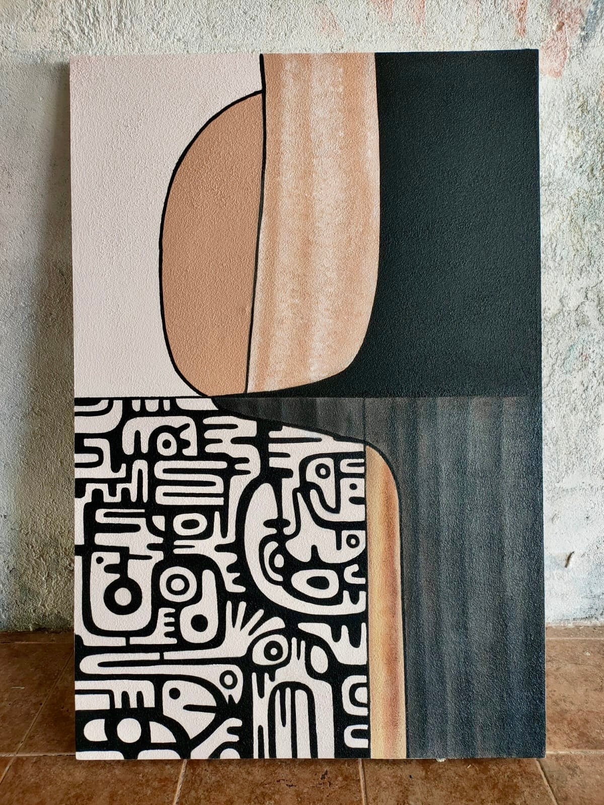 Vertical textured wall art with a top half of solid charcoal and sand-colored curved shapes, and a bottom half showcasing intricate monochromatic hand-drawn doodles and geometric symbols.