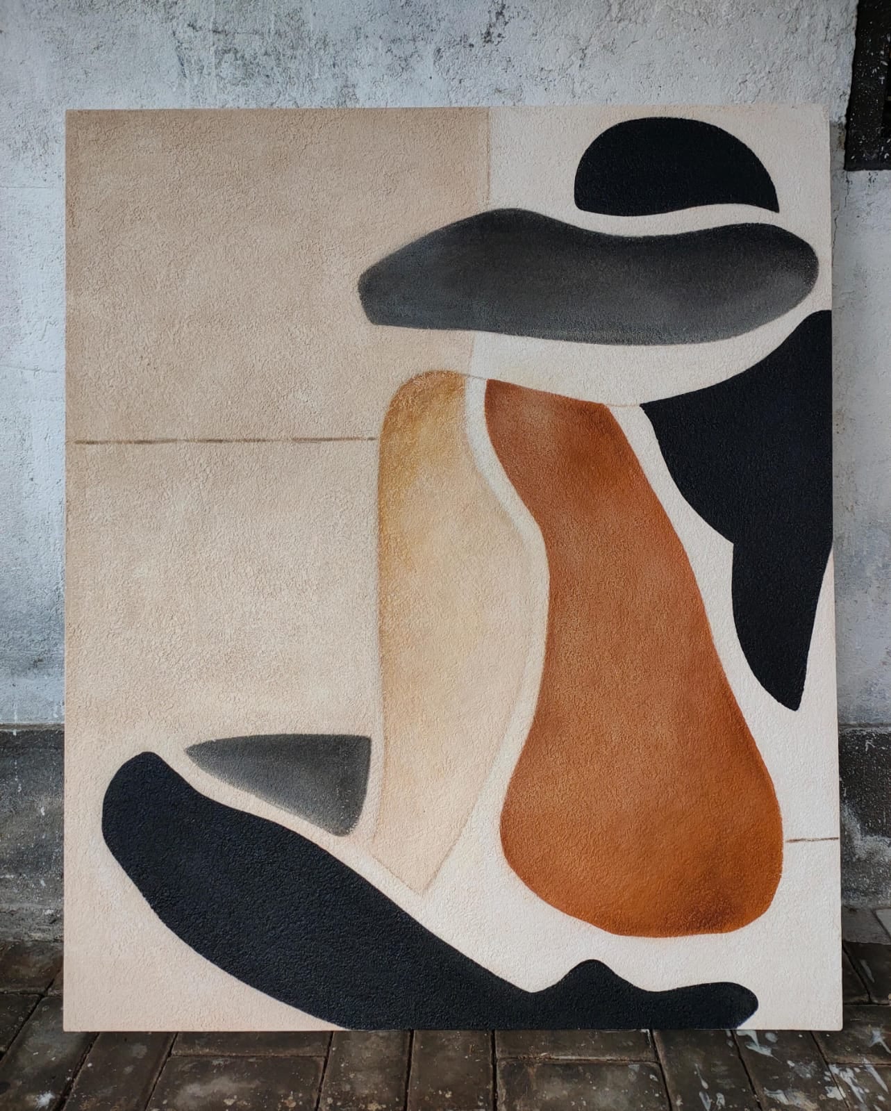 Large-scale textured abstract painting featuring organic silhouettes in terracotta, sand, and charcoal black. Minimalist wall art with a sand-plastered finish and earthy tones, perfect for wabi-sabi or modern natural interior design.